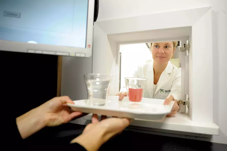 Christine Thompson passes a sample to a taster - JEB WALLACE-BRODEUR