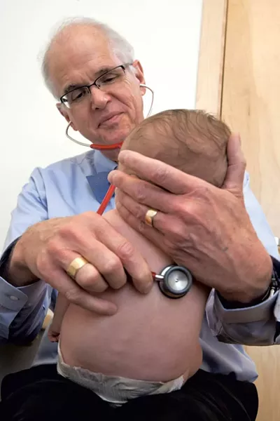 Dr. Joseph Hagan examines a patient - MATTHEW THORSEN