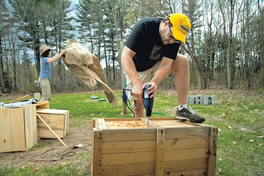 Ethan and Laura modifying crates for their garden - MATTHEW THORSEN
