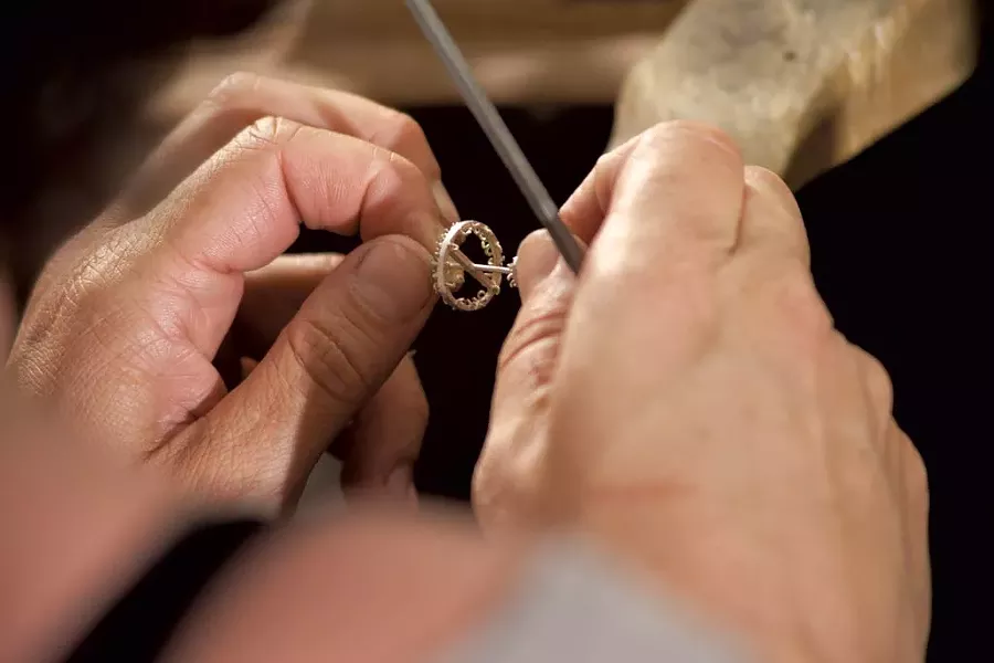 Frank assembling a chandelier earring - MATTHEW THORSEN