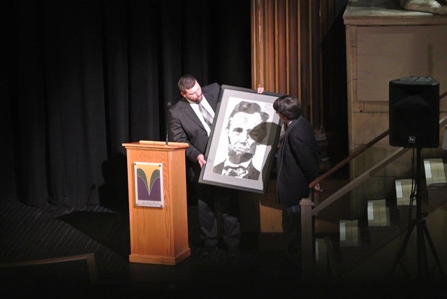 Headmaster Miller presents filmmaker Burns with a drawing of Abraham Lincoln. - COURTESY OF ARIA CARTER