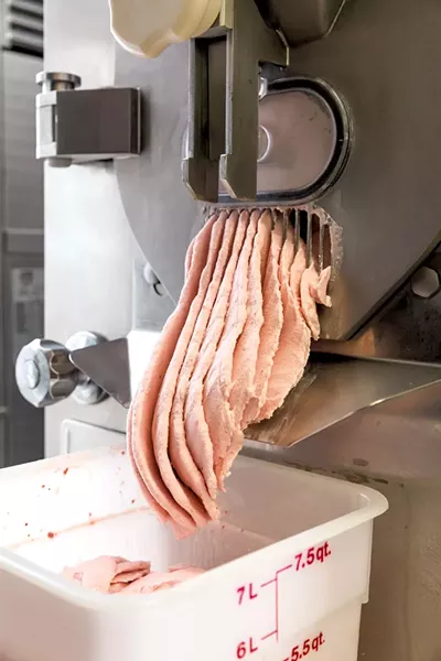 Ice cream pours out of the ice cream maker - OLIVER PARINI