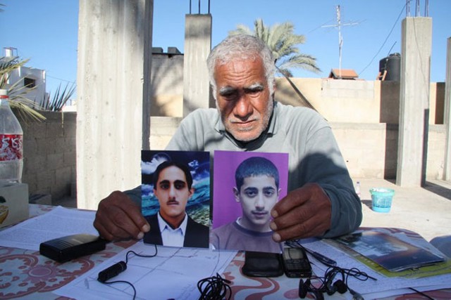 Muhammed Shurrab holds photos of his murdered sons