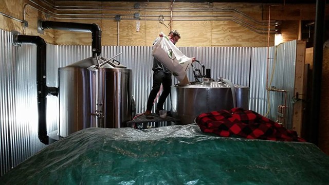 Nate Johnson mashing in the first brew in Prohibition Pig's new brewery last Friday. - COURTESY CHAD RICH/PROHIBITION PIG
