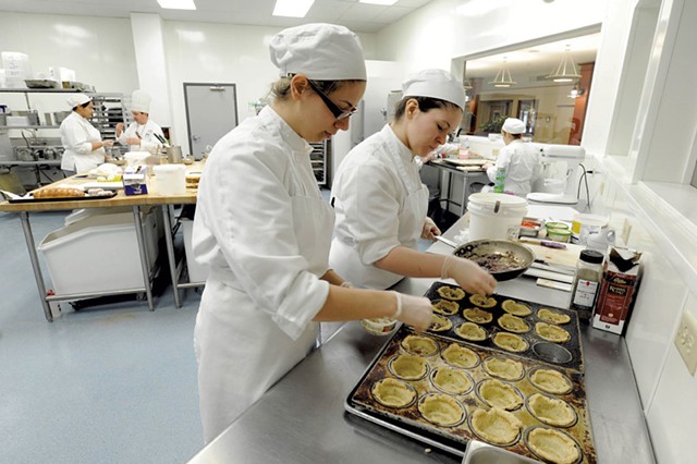 Rachel Kalinowski, left, and Lauren Layman fill savory mini quiches at NECI in Montpelier - JEB WALLACE-BRODEUR