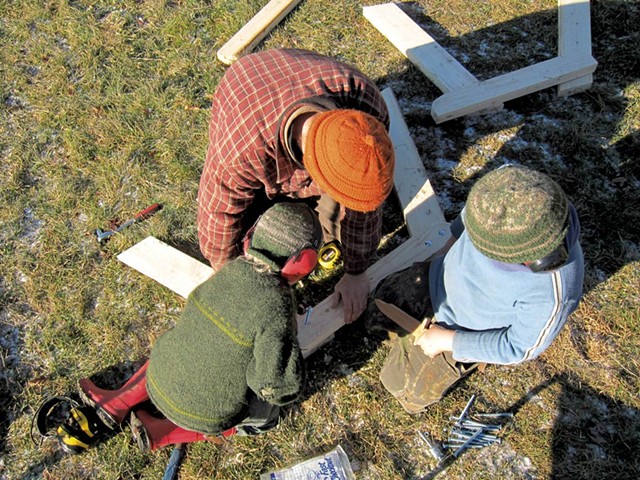 Rye, Ben and Fin Hewitt building a picnic table