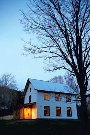 The big, southern-facing windows look out onto a slope filled with gnarled apple trees - COURTESY OF SARAH PRIESTAP AND JEFF PORTER
