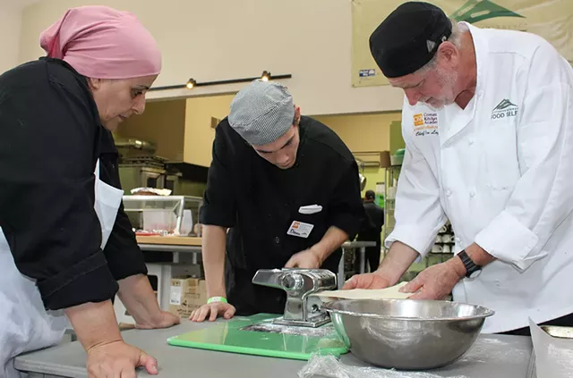 Community Kitchen Academy chef Jim Logan (right) with students - COURTESY OF COMMUNITY KITCHEN ACADEMY