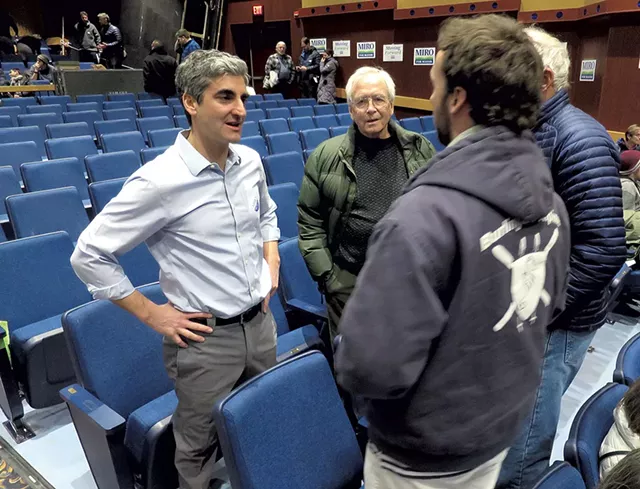 Mayor Miro Weinberger talking with constituents at the Democratic Caucus - MATTHEW THORSEN