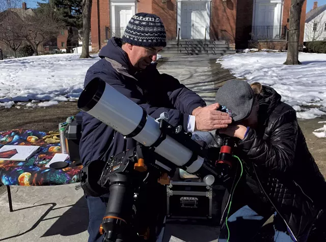 Tim Connolly helping someone look at the sun - COURTESY OF JACK ST. LOUIS