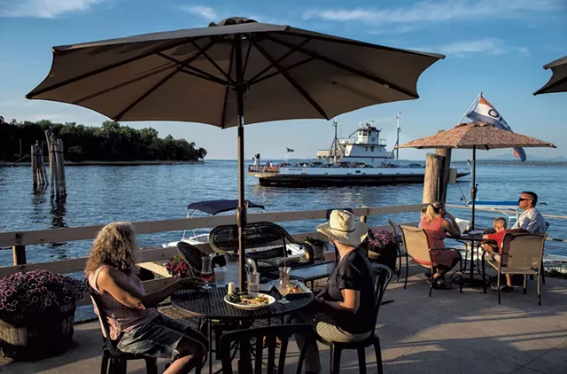 Patrons on the deck of the Old Dock Restaurant & Marina watching the arrival of the ferry - GLENN RUSSELL