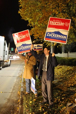 Lt. Gov. David Zuckerman, a Progressive/Democrat, and supporters wave to cars Monday night. - PAUL HEINTZ