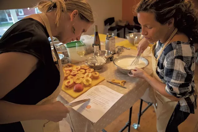 Students preparing peaches for dessert at a Richmond Community Kitchen class - JAMES BUCK