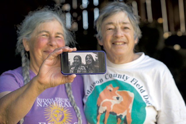 Cheesemakers Marjorie Susman (left) and Marian Pollack with a photo of themselves from the early days of Orb Weaver Farm - CALEB KENNA