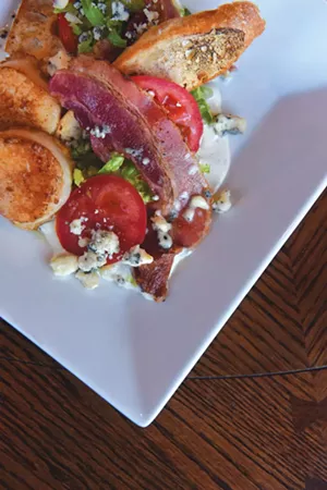 A BLT salad, with romaine, "VT Smoke & Cure" bacon, bleu cheese dressing and crostini at the Barrows House in Dorset, Vt. - SARAH PRIESTAP