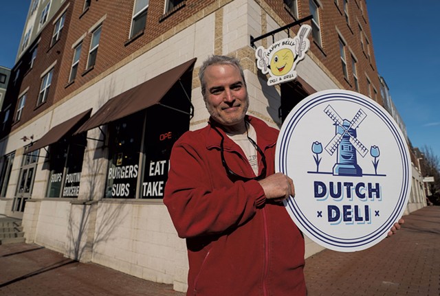 Chris West with the new Dutch Deli sign - COURTESY OF DUTCH DELI