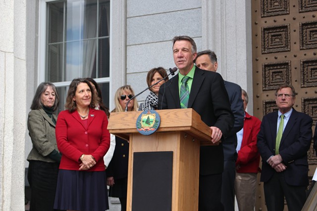 Secretary Deb Markowitz, left in red, at a Green Up Day press conference in April with Lt. Gov. Phil Scott. - FILE: PAUL HEINTZ