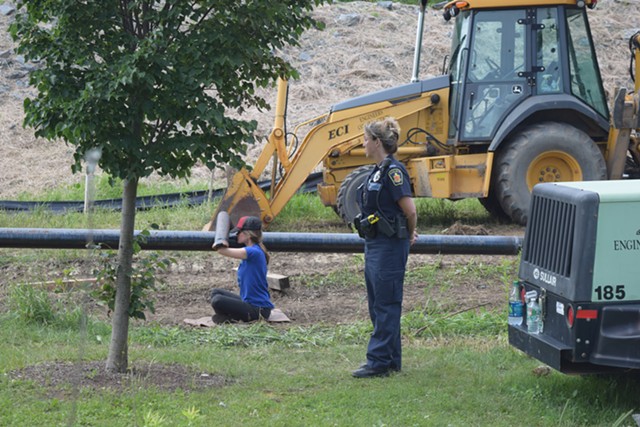 Johanna Anderson sits chained Thursday morning to a pipe at the Vermont Gas pipeline construction site in Essex. - TERRI HALLENBECK