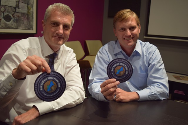 TDI New England president and chief executive officer Donald Jessome (left) and Project Manager Josh Bagnato hold disks that represent the circumference of two transmission lines the company proposes to place under Lake Champlain. - TERRI HALLENBECK