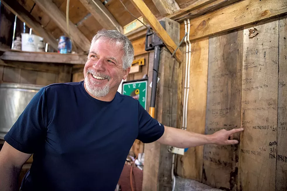 Dave Bishop points to his 19-year tally of syrup production - JAMES BUCK