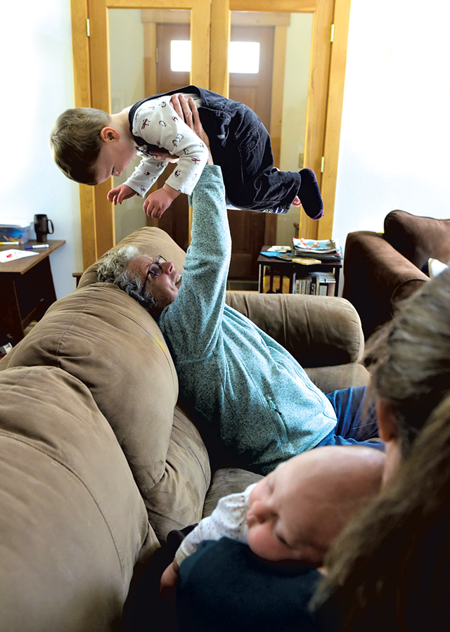 Postpartum Angel Didi Brush plays with 2-year-old Eric while his mom, Helen Sullivan, holds 7-week-old daughter Vera - JEB WALLACE-BRODEUR