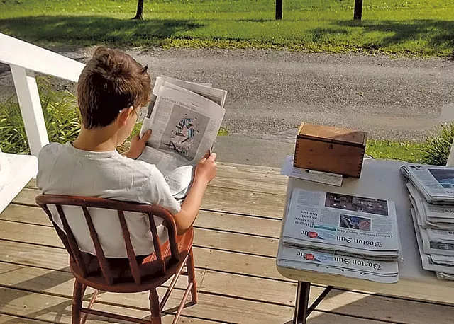 Oliver Szott reading — and selling — the paper - COURTESY OF PAMELA FRASER