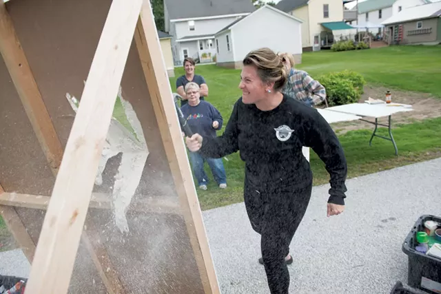 Christina Kumka swings a hammer to make a hole in drywall during Morgan Over's We Can Fix It class for women in Rutland - CALEB KENNA