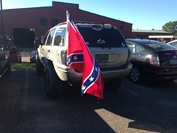 The Confederate flag flies Wednesday from a car at the BPW employee lot. - MOLLY WALSH
