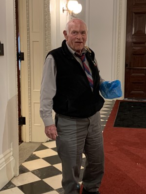 Sen. Dick Sears shows off his poop bag Tuesday in the Vermont Statehouse - PAUL HEINTZ