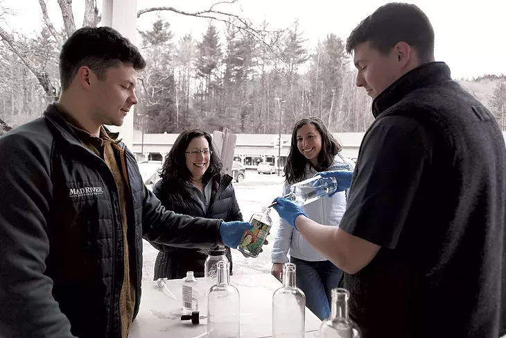 Mad River Distillers staff filling bottles for Neile Eisner and Anna Friedman - KEVIN MCCALLUM