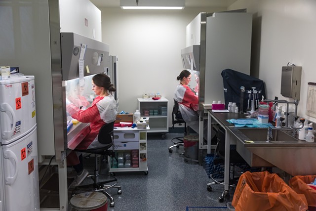 Workers running coronavirus tests at the Vermont Health Department lab - OLIVER PARINI