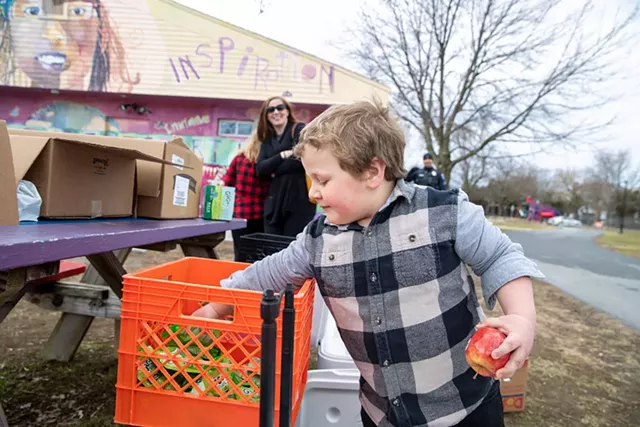 Lucas, 4, digging deep for some free GoGo squeeZ apple sauce - JAMES BUCK