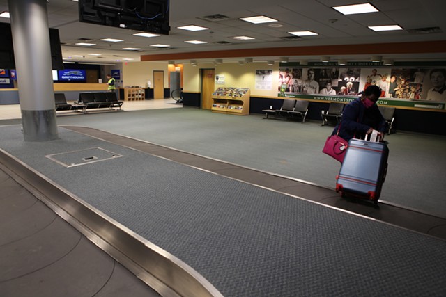Mary Murphy, a nurse from South Carolina, retrieving her luggage on Tuesday - KEVIN MCCALLUM