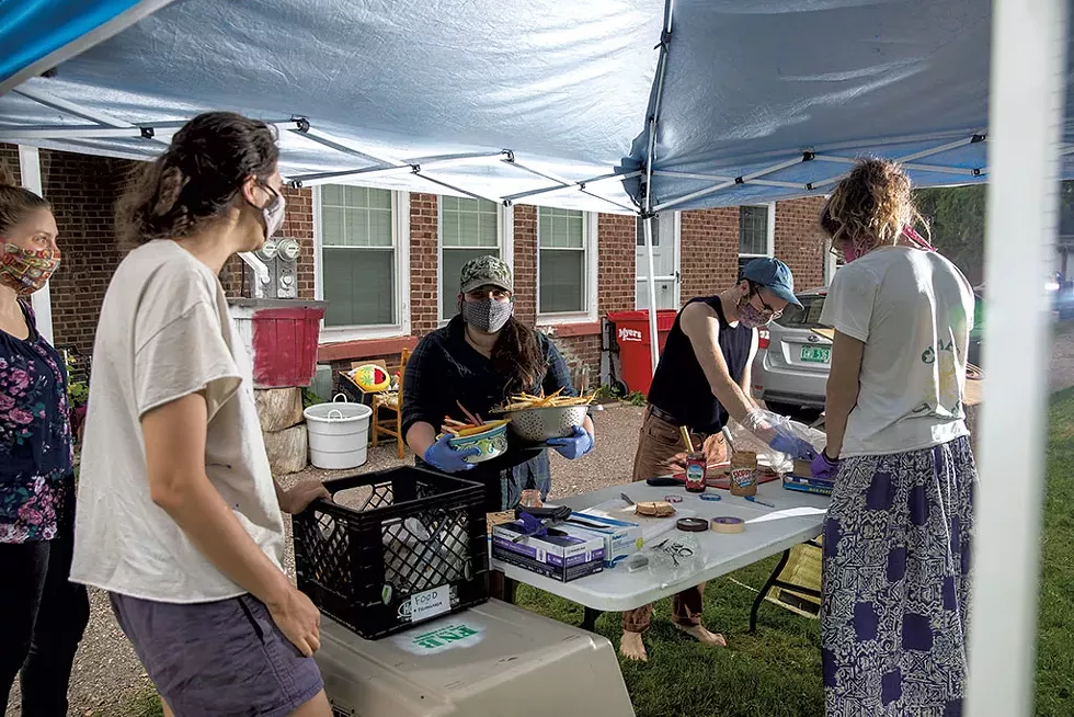 Food Not Bombs volunteers distributing food at the Marketplace Garage in Burlington - JEB WALLACE-BRODEUR