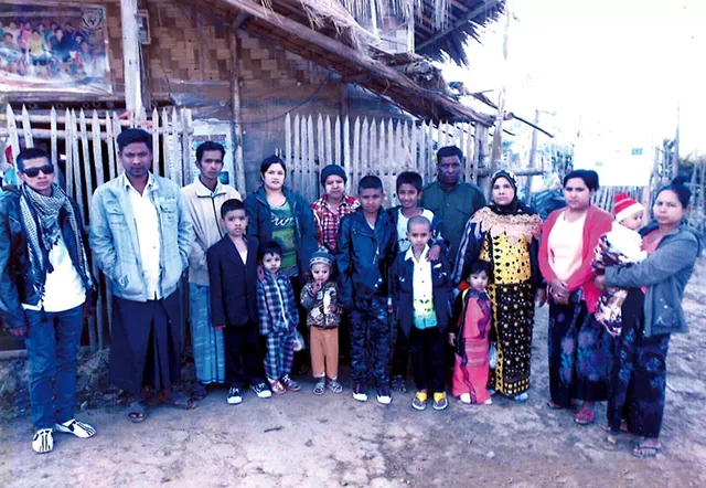 Me Me (in yellow and black) and her family in a refugee camp in Thailand in 2014 - COURTESY OF ME ME'S FAMILY