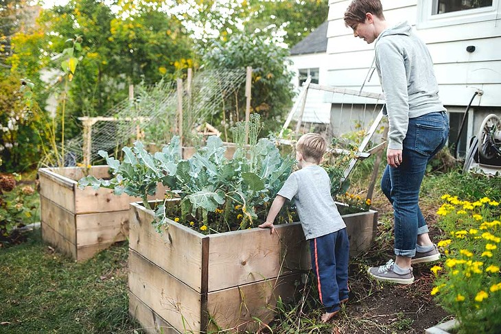 Maresa Nielson tending the garden with one of her foster sons - SARAH PRIESTAP