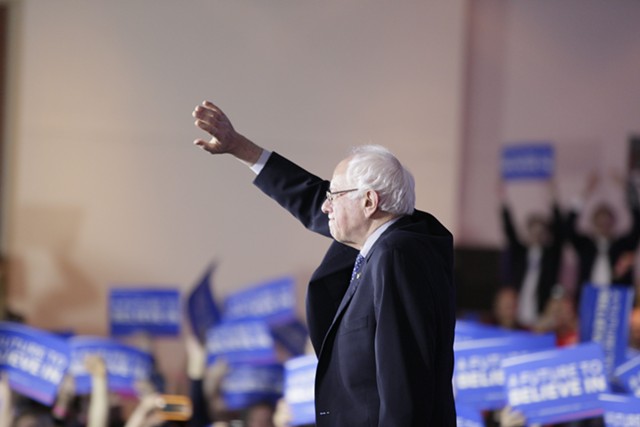 Sen. Bernie Sanders greets supporters Monday night after scoring a "virtual tie" in Iowa. - KRISTIAN DAY