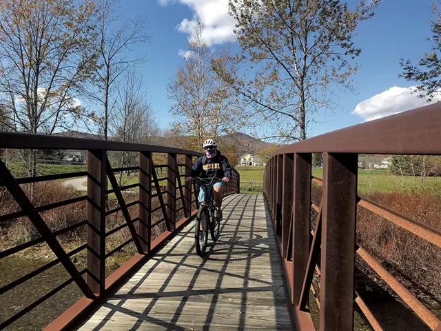 A cyclist on the Stowe Recreation Path - SALLY POLLAK ©️ SEVEN DAYS