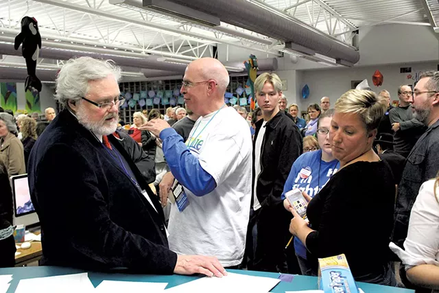 Urbandale caucus chair Jerry Tormey and vice chair Suki Sanford Monday at the Rolling Green Elementary School - PAUL HEINTZ