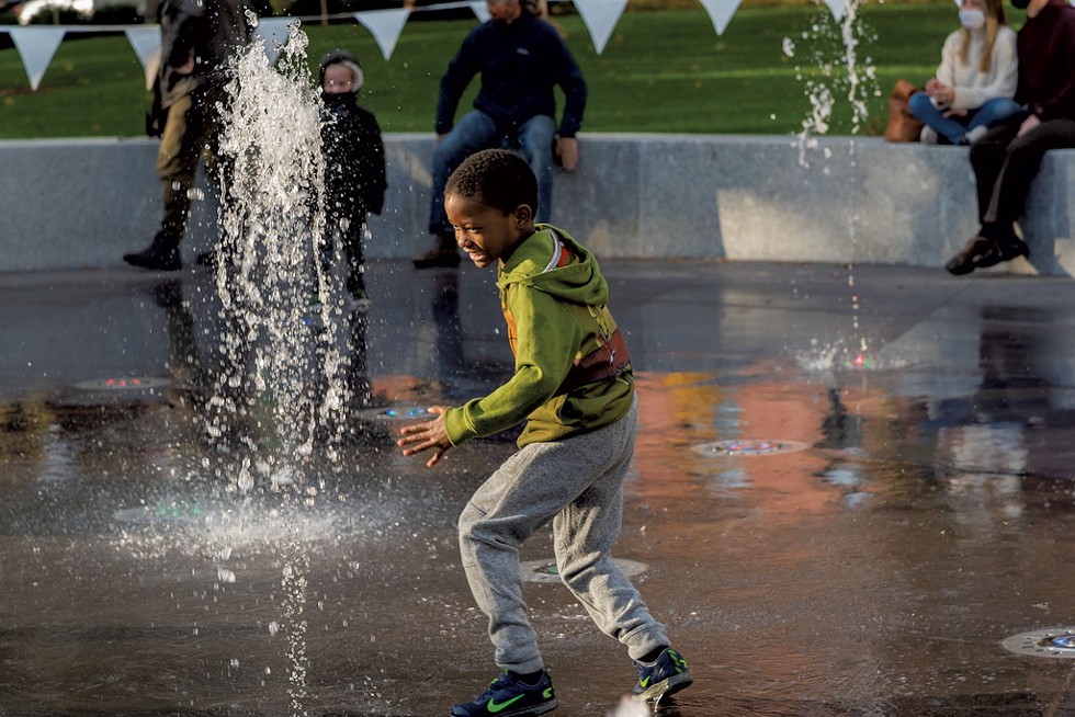 A child plays in the the new fountain at Burlington's City Hall Park - RENEE GREENLEE | COURTESY OF BURLINGTON CITY ARTS