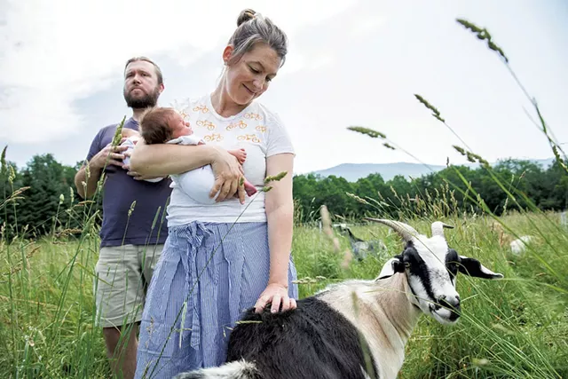 Keith Drinkwine and Lisa Burritt Drinkwine holding their twin sons - COURTESY OF AMANDA HERZBERGER