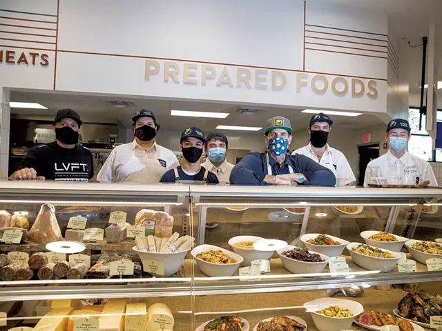 Matt Jennings (leaning on case) with staff at Healthy Living Market & Café in Williston - JAMES BUCK