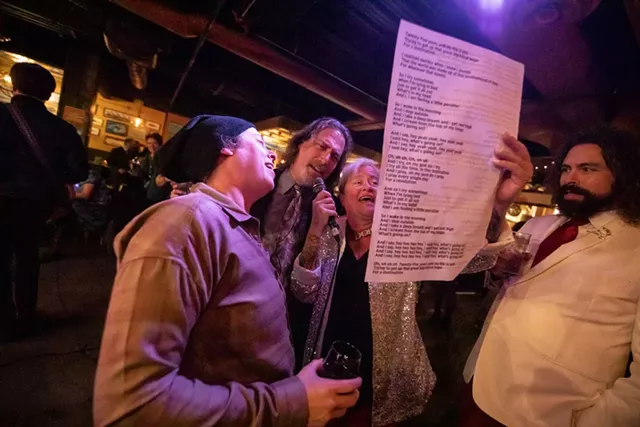 Account executive Kaitlin Montgomery, writer Ken Picard, and art director Diane Sullivan sing "The Weight" at Seven Days' 2019 holiday party. - FILE: LUKE AWTRY