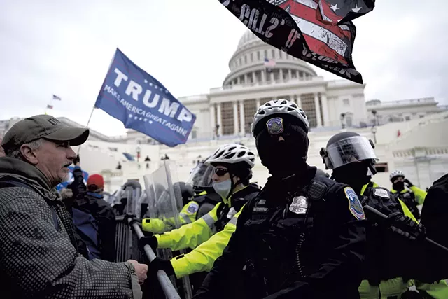 Trump supporters and police officers at Capitol Hill on January 6 - © DREAMSTIME.COM/JULIAN LESHAY