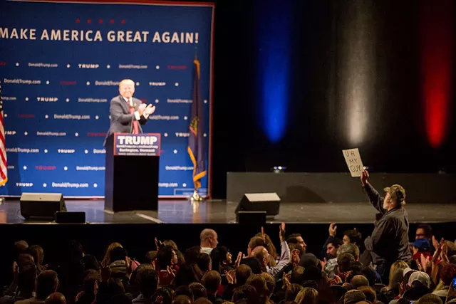 A Trump supporter holds up a sign that reads, "U R MY GUY" during a rally at the Flynn Center in Burlington - JAMES BUCK