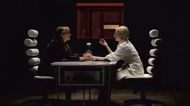 HEAD TRIP Riseborough (right) and Leigh discuss brain-hacking assassination techniques in Cronenberg's sci-fi film. - COURTESY OF NEON