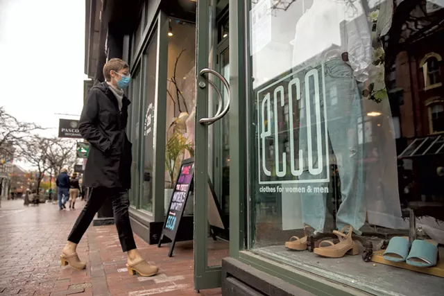 A customer walking into Ecco Clothes in Burlington - JAMES BUCK