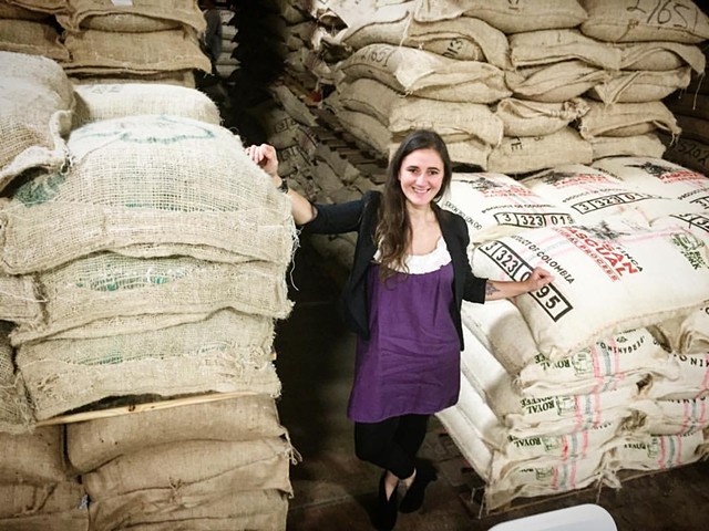 Magdelena Van Dusen with green coffee bags - COURTESY OF BRIO COFFEEWORKS