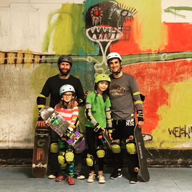 Parks director Jesse Bridges, left, and Mayor Miro Weinberger get a skateboarding lesson with their daughters. - COURTESY OF THE MAYOR'S OFFICE