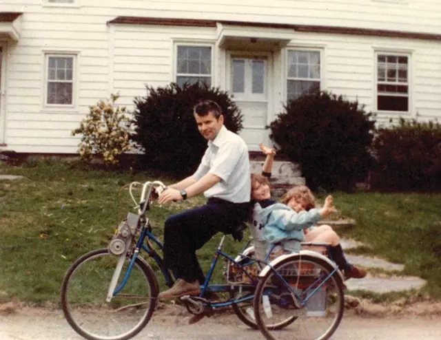 Bill with daughters Elizabeth and Patty riding an electric bicycle he built - COURTESY OF THE PENNEBAKER FAMILY